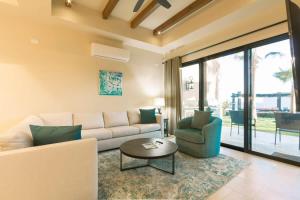 a living room with a couch and a table at Copala At Quivira-Poolside Ground Floor Oceanview in Cabo San Lucas