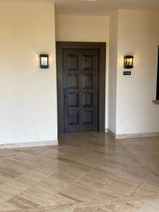 an empty room with a door and a tile floor at Copala At Quivira-Poolside Ground Floor Oceanview in Cabo San Lucas