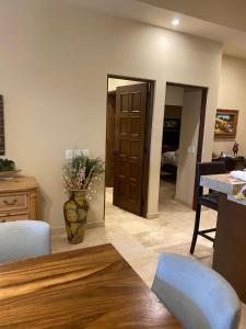 a living room with a mirror and a table and chairs at Copala At Quivira-Poolside Ground Floor Oceanview in Cabo San Lucas +26 photos
