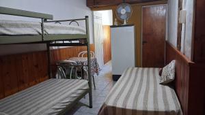 a room with two bunk beds and a table at Depto III in Capilla del Monte