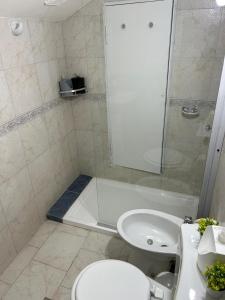 a bathroom with a shower and a toilet and a sink at Pasala Lindo in Tandil