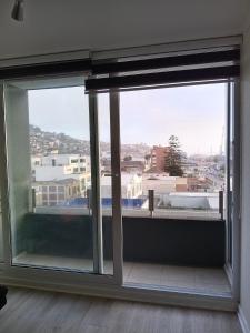 an open window with a view of a city at Departameto comodo Coquimbo HA in El Cerrillo