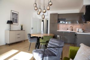 a kitchen with a table and chairs in a room at Vista Pálava - Apartmán Pasohlávky in Pasohlávky