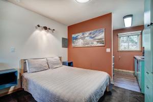 a bedroom with a bed with an orange wall at Park Meadows 7D by Ski Country Resorts in Breckenridge