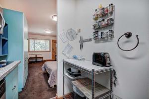 a small kitchen with a table with a microwave at Park Meadows 7D by Ski Country Resorts in Breckenridge