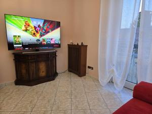 a living room with a flat screen tv on the wall at Appartamento Galileo Ferraris, in Vercelli