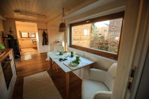 a living room with a table and a window at Tiny house with view of nature in Coesfeld +34 photos