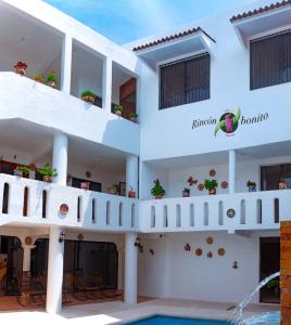a large white building with a swimming pool at Casa Rincón Bonito in Puerto Escondido