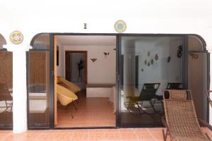 an open door to a room with chairs and tables at Casa Rincón Bonito in Puerto Escondido +3 photos