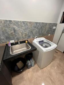a bathroom with a sink and a trash can at Dos habitaciones - apartment CDE - Area 4 in Ciudad del Este +20 photos