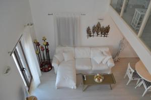 a living room with a white couch and a table at Villa Aristoteles in Halki