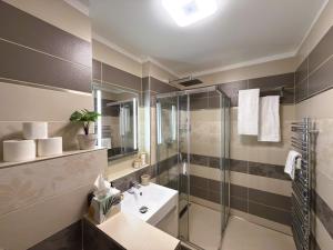 a bathroom with a sink and a shower at K&K Suite Frymburk in Frymburk