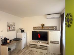a living room with a flat screen tv on a tv stand at K&K Suite Frymburk in Frymburk +8 photos