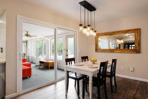 a dining room with a table and chairs and a mirror at Pebble Retreat-Private Pool-7 Mins Arizona State in Tempe