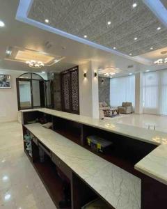 a large kitchen with a long counter in a room at Seaside Two Bedroom Charming Apt in Salalah