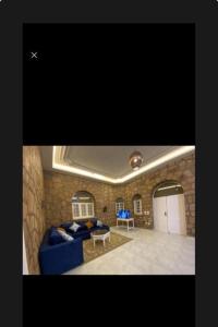 a living room with a blue couch and a table at Villa Nile Queen -guest house in Luxor