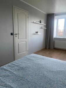 an empty room with a bed and a window at Apartment in the city centre of Tapa in Tapa