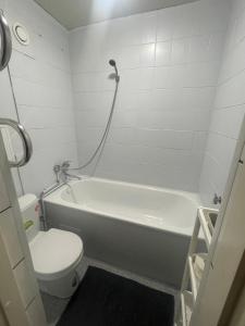 a bathroom with a white tub and a toilet at Apartment in the city centre of Tapa in Tapa