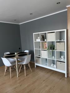 a dining room with a table and a book shelf at Apartment in the city centre of Tapa in Tapa