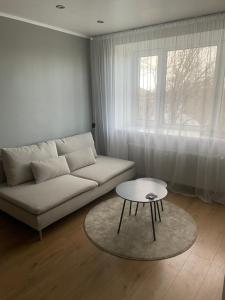 a living room with a white couch and a table at Apartment in the city centre of Tapa in Tapa