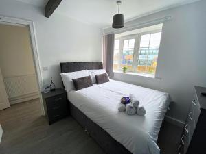 a bedroom with a bed with two teddy bears on it at Thornton Road Lodge -Room 1 in Bradford