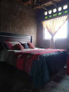 Ένα ή περισσότερα κρεβάτια σε δωμάτιο στο Lodge Malezas del Desierto