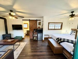 a bedroom with a bed and a living room at The Loose Moose Cabin #10 At Downtown Grand Lake in Grand Lake
