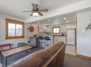 a living room with a couch and a kitchen at The Loose Moose Book The 11-unit Mountain Lodge! in Grand Lake