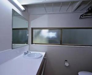 a bathroom with a sink and a mirror at Ski Chalet Ohakune Alpine Village in Ohakune
