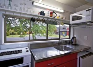 a kitchen with a sink and a window at Ski Chalet Ohakune Alpine Village in Ohakune