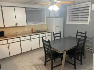 a kitchen with a table and chairs and a refrigerator at Emotions in Gatineau