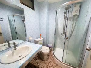 a bathroom with a sink and a shower and a toilet at P&I Group Karon Beach Room-1 in Karon Beach