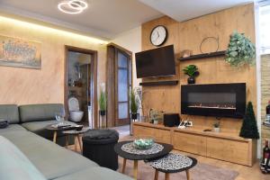 a living room with a couch and a fireplace at Start Apartments LUX KOPAONIK in Kopaonik