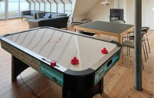 a ping pong table with two red balls on it at 4 Bedroom Beach Front Home In Vinderup in Vinderup