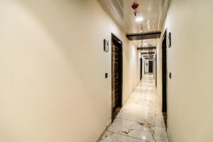 an empty hallway with white walls and a ceiling at Hotel O JPS Galaxy Hotel in New Delhi