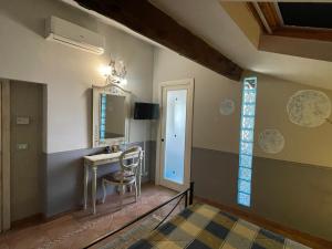 a room with a vanity and a table and a mirror at B&B Le Stanze del Moro in Pállare