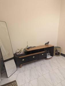 a living room with a desk and a chair at Ocean Breeze Apartments in Dar es Salaam +1 photo