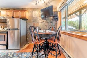 a kitchen with a table and chairs and a refrigerator at Park Meadows 6A by Ski Country Resorts in Breckenridge +28 photos