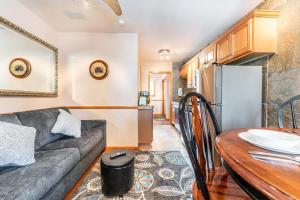 a living room and kitchen with a couch and a table at Park Meadows 6A by Ski Country Resorts in Breckenridge