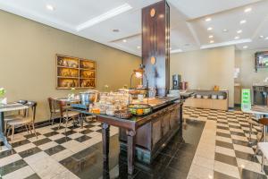 a kitchen with a counter with food on it at Batel Luxury - Próx Pátio Batel in Curitiba +32 photos