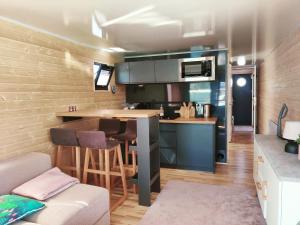a small kitchen with a bar in a tiny house at Floating Downtown Apartment in Gothenburg