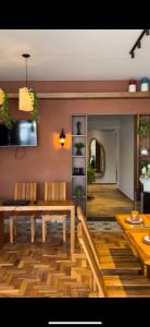 a dining room with a wooden table and chairs at Pousada Grão & Vinha in Espirito Santo Do Pinhal