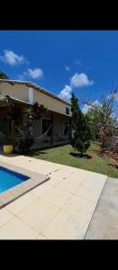 a house with a swimming pool in front of it at Canto dos pássaros in Entre Rios