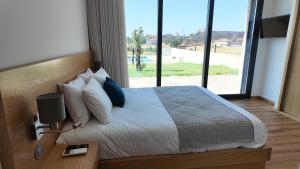 a bedroom with a large bed with a large window at Casa Memórias da Lucinda in São Gens +28 photos