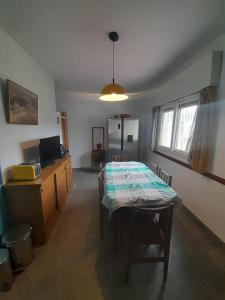 a living room with a table and a room with a kitchen at Departamentos Tala y Tuyú in San Clemente del Tuyu +15 photos