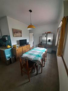 a kitchen with a table with chairs and a refrigerator at Departamentos Tala y Tuyú in San Clemente del Tuyu