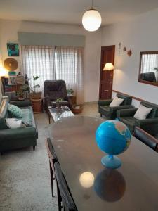 a living room with a table with a globe on it at Departamentos Tala y Tuyú in San Clemente del Tuyu