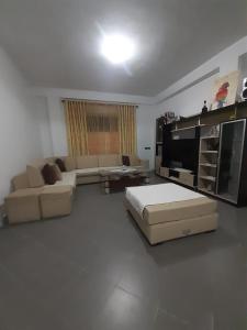 a living room with a couch and a television at Villas Mari-Anna for rent best view in Durrës