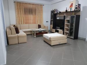 a living room with couches and a flat screen tv at Villas Mari-Anna for rent best view in Durrës