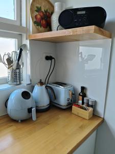 a kitchen counter with pots and pans on it at Wake up and smell the Coffee in Woy Woy